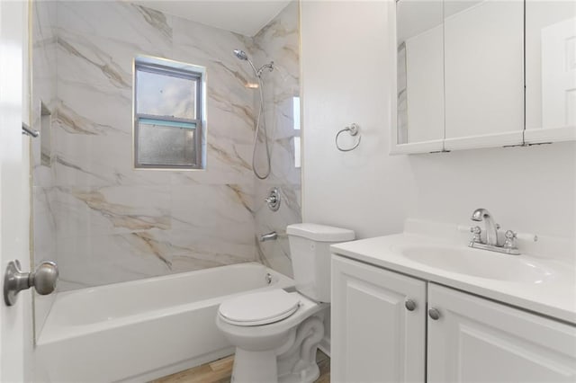 full bathroom featuring hardwood / wood-style flooring, toilet, vanity, and tiled shower / bath