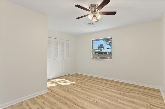 unfurnished bedroom featuring ceiling fan, light hardwood / wood-style flooring, and a closet