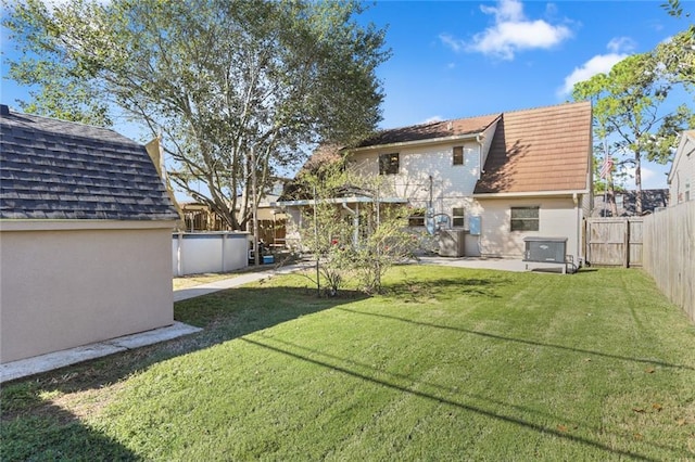 view of yard featuring a patio and a swimming pool