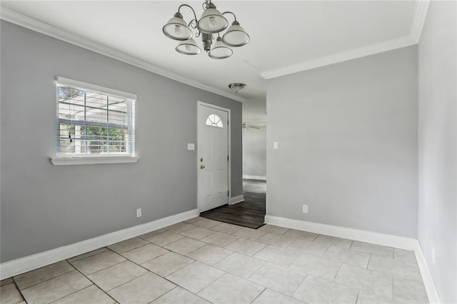 foyer entrance with light tile patterned floors, ceiling fan with notable chandelier, and crown molding