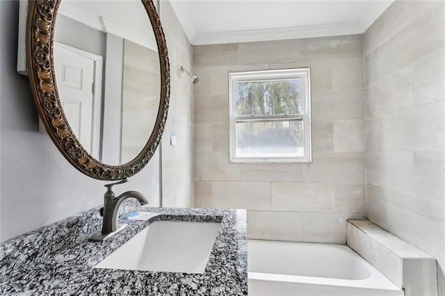 bathroom featuring vanity and tiled shower / bath