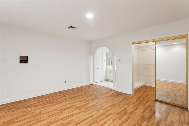 unfurnished bedroom featuring light hardwood / wood-style flooring and a closet