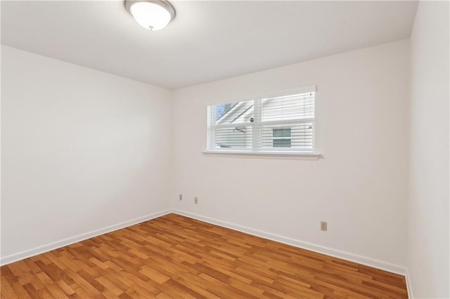 spare room featuring wood-type flooring