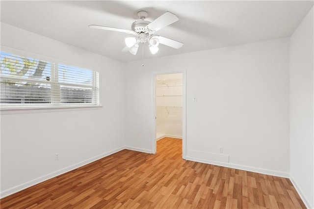 unfurnished room featuring light hardwood / wood-style flooring and ceiling fan