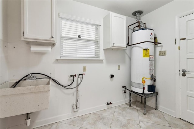 clothes washing area featuring cabinets, gas water heater, washer hookup, hookup for a gas dryer, and light tile patterned floors