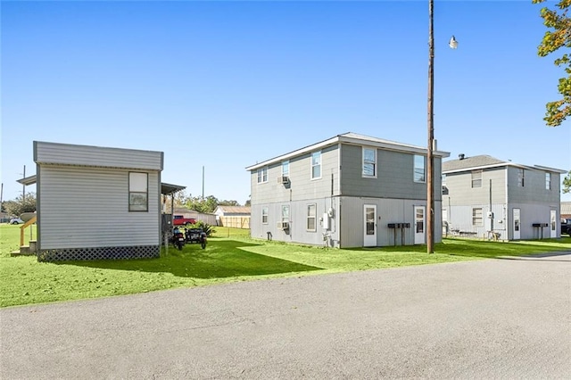 view of side of home with a lawn