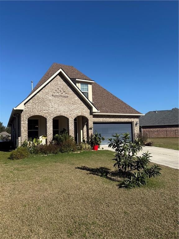 view of front of home with a garage and a front lawn