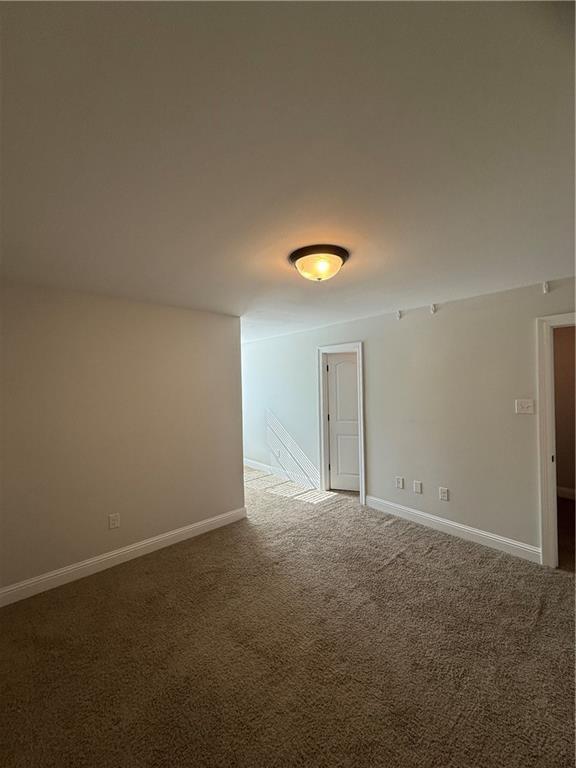 unfurnished room featuring carpet