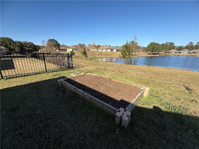 view of property's community featuring a water view and a lawn