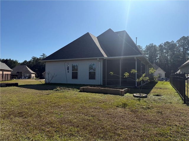 back of property featuring a yard and a sunroom