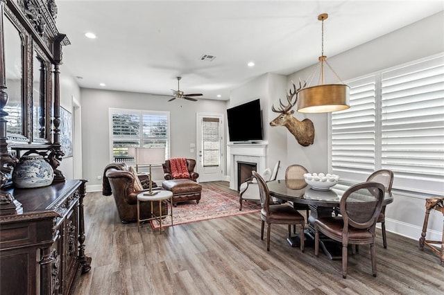 dining space featuring ceiling fan and hardwood / wood-style floors