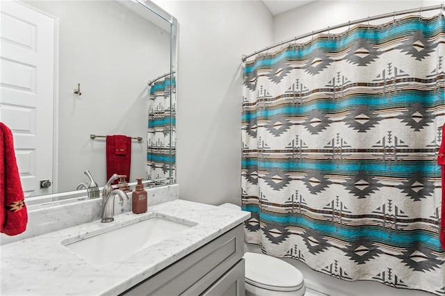 bathroom featuring vanity, toilet, and walk in shower