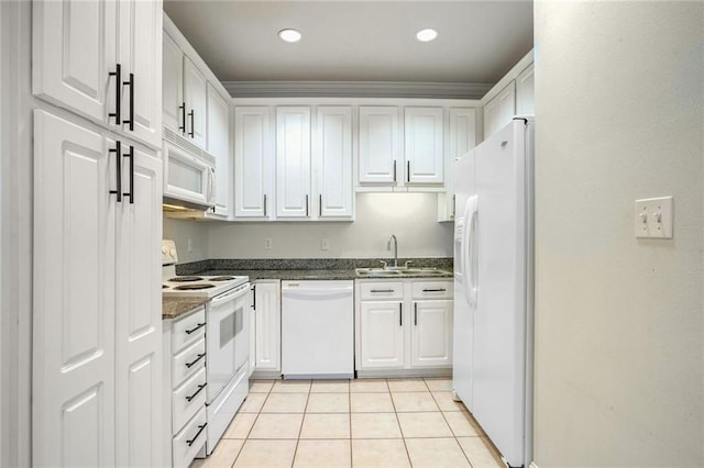 kitchen with white cabinetry, sink, light tile patterned floors, and white appliances