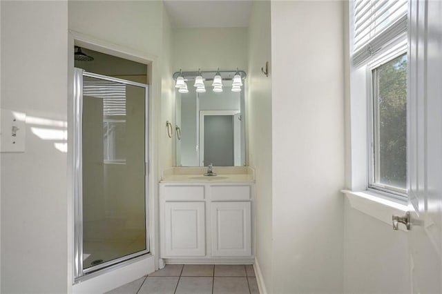 bathroom featuring tile patterned floors, vanity, and walk in shower