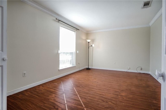 empty room featuring hardwood / wood-style flooring and crown molding