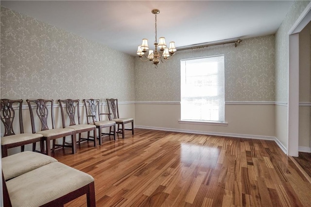 living area with hardwood / wood-style flooring and a notable chandelier