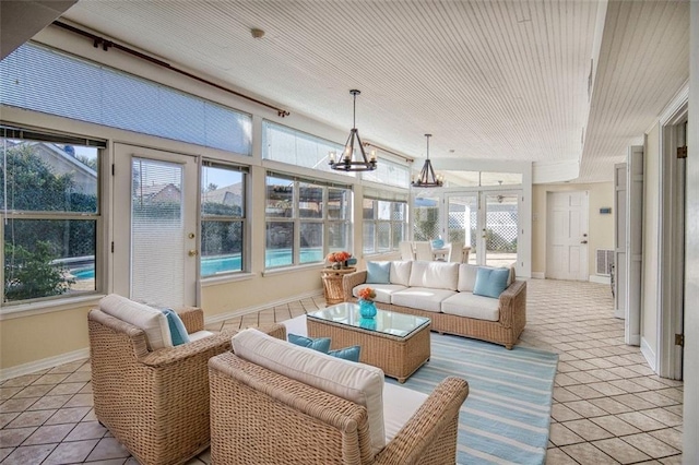 sunroom / solarium with a notable chandelier