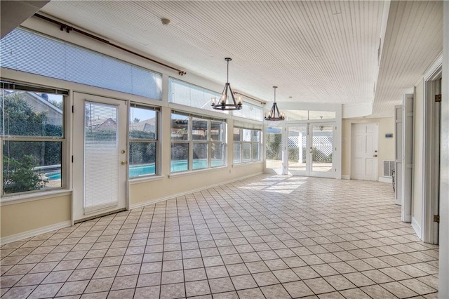 unfurnished sunroom with an inviting chandelier