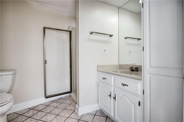 bathroom featuring vanity, a shower with door, tile patterned floors, and toilet