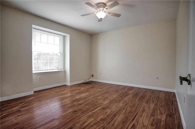 empty room featuring ceiling fan and dark hardwood / wood-style floors