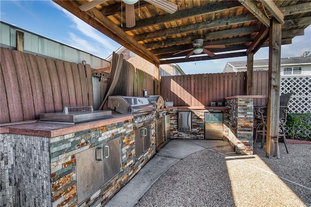 view of patio / terrace with ceiling fan and an outdoor kitchen