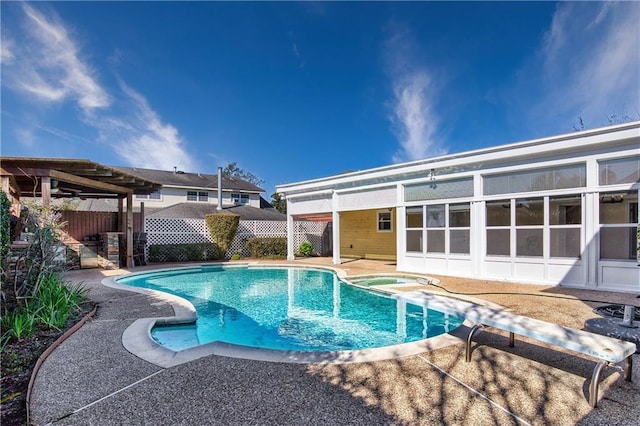 view of pool with a diving board, a hot tub, and a patio