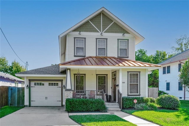 view of front of property with a porch, a garage, and a front lawn