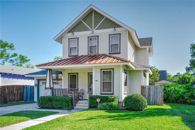 view of front of home featuring covered porch and a front yard