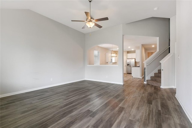 unfurnished living room with ceiling fan, lofted ceiling, and dark wood-type flooring