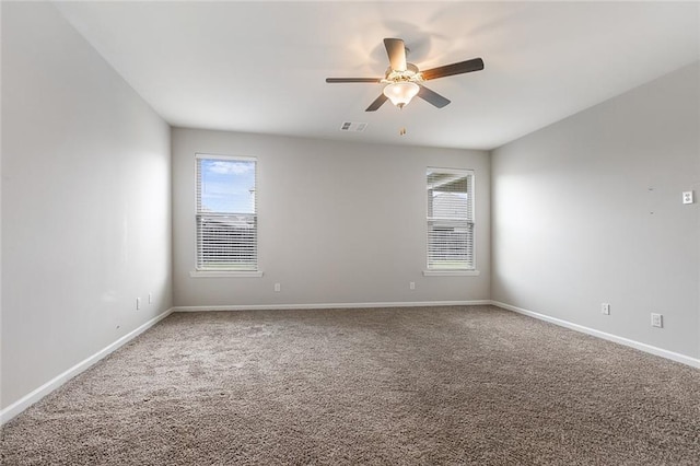 spare room featuring carpet floors and ceiling fan