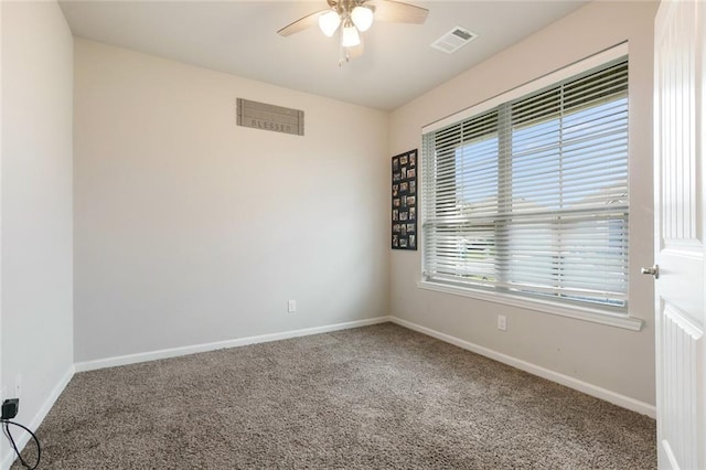 spare room featuring carpet, a wealth of natural light, and ceiling fan