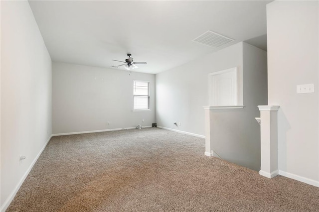 carpeted spare room with ceiling fan