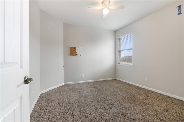 unfurnished room with ceiling fan and carpet