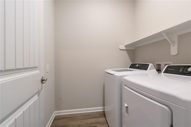 clothes washing area featuring independent washer and dryer and dark wood-type flooring