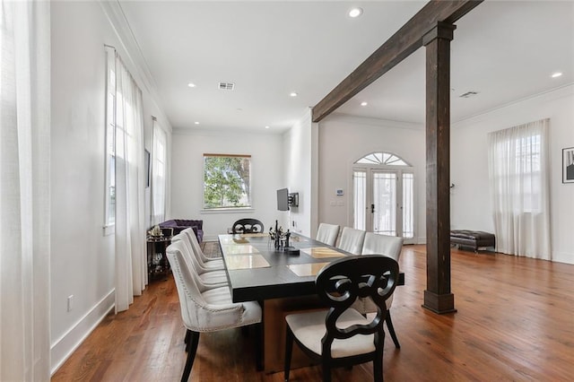 dining area with hardwood / wood-style flooring and crown molding