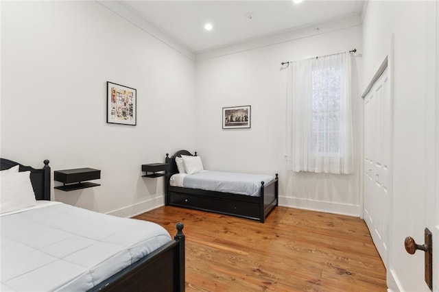 bedroom featuring hardwood / wood-style floors and ornamental molding