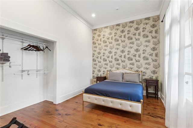 bedroom featuring hardwood / wood-style flooring and crown molding