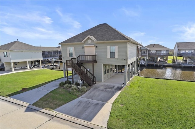 view of front of property with a carport, a water view, and a front yard