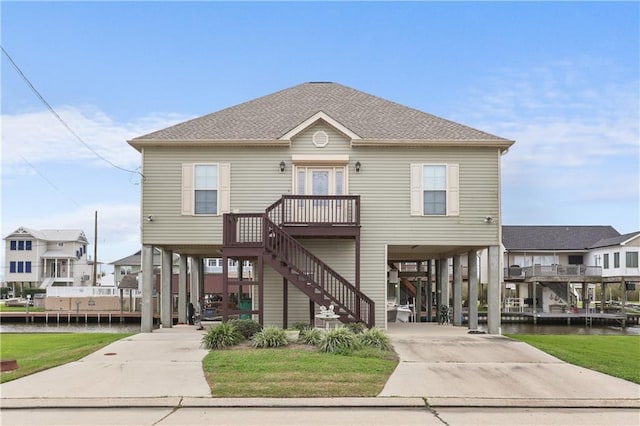 view of front of house with a carport and a water view