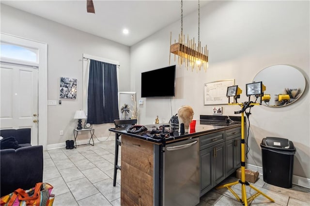 kitchen with a breakfast bar area, kitchen peninsula, light tile patterned flooring, and stainless steel dishwasher