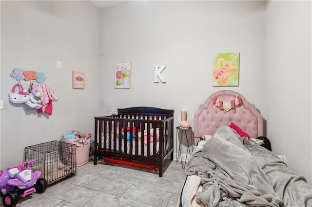 tiled bedroom featuring a nursery area