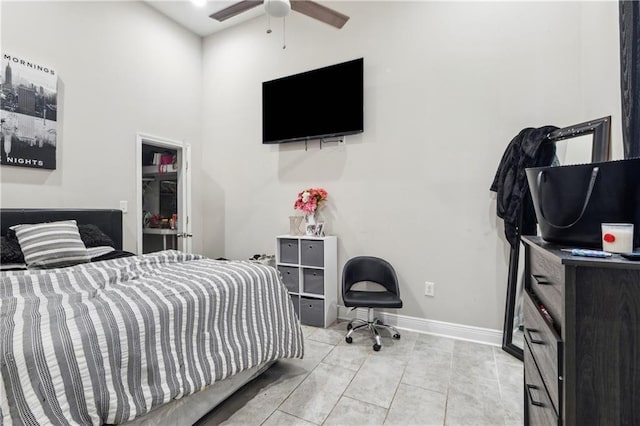 tiled bedroom featuring ceiling fan