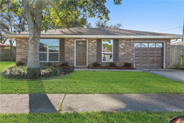 ranch-style home featuring a garage and a front lawn