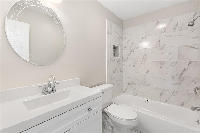 full bathroom featuring vanity, tiled shower / bath combo, and toilet