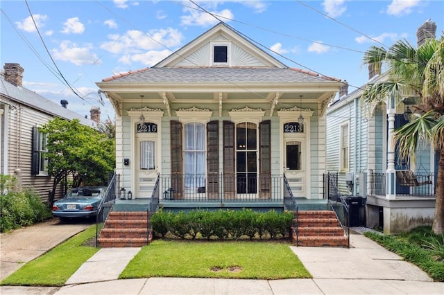 bungalow with covered porch and a front yard