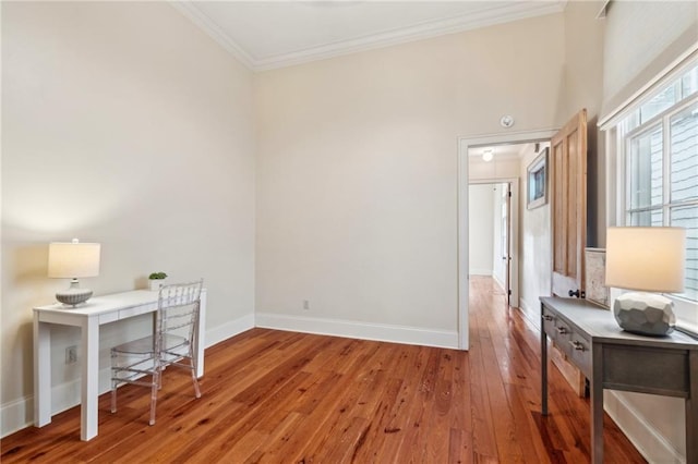 home office featuring light hardwood / wood-style flooring and ornamental molding