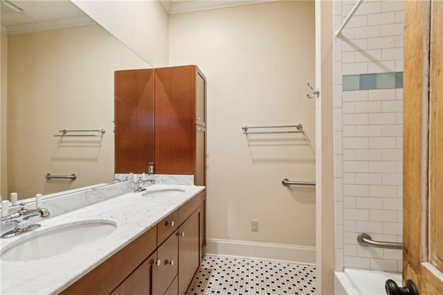 bathroom featuring vanity, tiled shower / bath combo, and ornamental molding