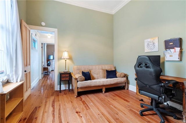 office with light hardwood / wood-style flooring and ornamental molding