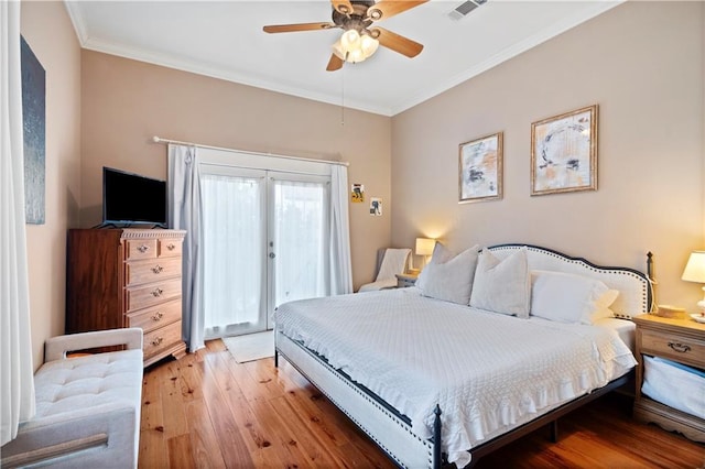 bedroom with ceiling fan, french doors, ornamental molding, and light wood-type flooring