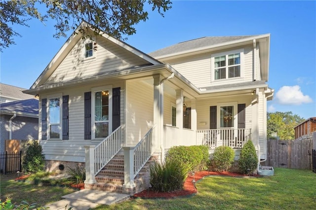 view of front facade with covered porch and a front yard